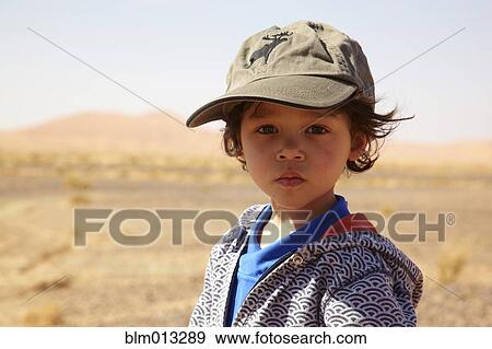Serious mixed race boy in cap View Large Photo Image Stock Photo - Serious mixed race boy in cap. Fotosearch