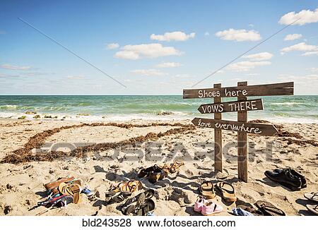 Shoes and signs for wedding on ocean beach View Large Photo Image Stock Photo - Shoes and signs for wedding on ocean beach. Fotosearch