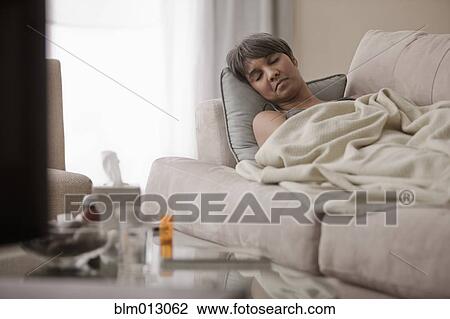 Sick mixed race woman laying on sofa View Large Photo Image Stock Image - Sick mixed race woman laying on sofa. Fotosearch