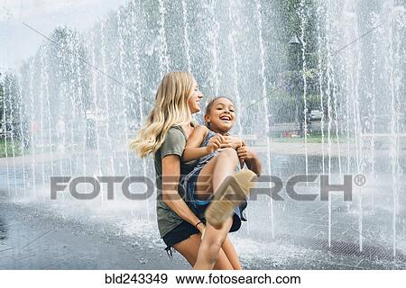 Sisters playing near fountain View Large Photo Image Stock Photo - Sisters playing near fountain. Fotosearch