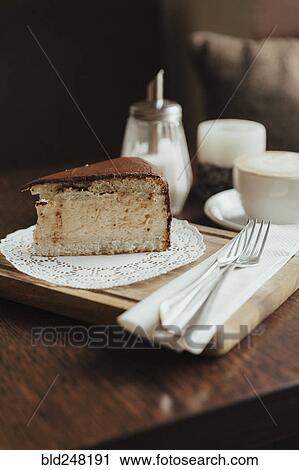 Stock Image - Slice of cake on doily. Fotosearch