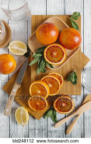 Stock Image - Sliced oranges on cutting board. Fotosearch