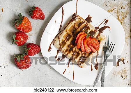 Sliced strawberries and chocolate syrup on waffle View Large Photo Image Stock Image - Sliced strawberries and chocolate syrup on waffle. Fotosearch