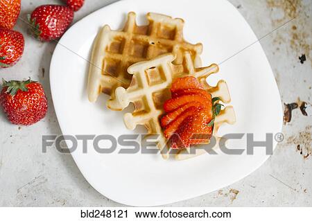 Sliced strawberries on waffles View Large Photo Image Stock Image - Sliced strawberries on waffles. Fotosearch