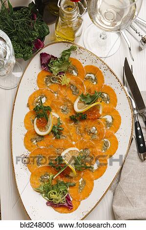 Stock Photography - Slices of fish and caviar with lemons. Fotosearch