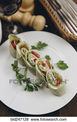 Stock Photo - Slices of rolled sandwich on plate. Fotosearch
