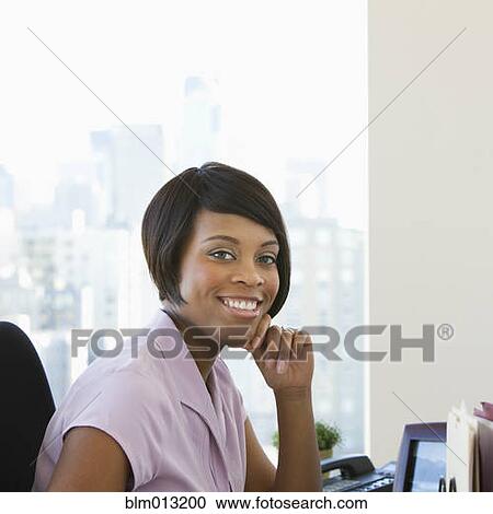 Stock Image - Smiling African American businesswoman. Fotosearch