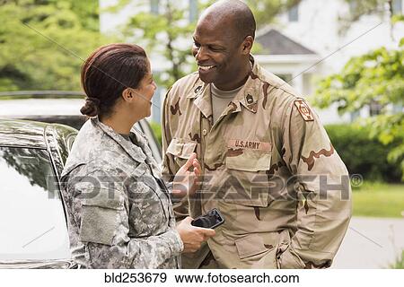 Smiling African American soldier couple talking near car View Large Photo Image Stock Photo - Smiling African American soldier couple talking near car. Fotosearch