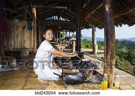 Smiling Asian woman cooking on patio outdoors View Large Photo Image Picture - Smiling Asian woman cooking on patio outdoors. Fotosearch