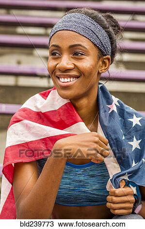Smiling black athlete wrapped in American flag View Large Photo Image Stock Image - Smiling black athlete wrapped in American flag. Fotosearch