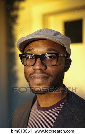 Smiling Black man standing outdoors View Large Photo Image Stock Image - Smiling Black man standing outdoors. Fotosearch