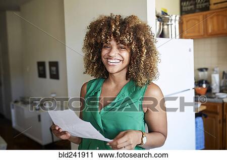 Smiling Black woman holding paperwork View Large Photo Image Stock Image - Smiling Black woman holding paperwork. Fotosearch