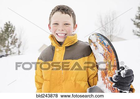 Smiling boy posing with snowboard in winter View Large Photo Image Stock Photo - Smiling boy posing with snowboard in winter. Fotosearch