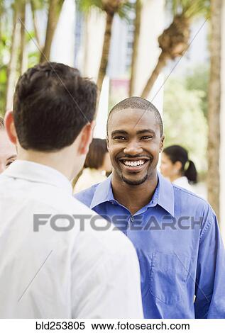 Smiling business people outdoors View Large Photo Image Stock Photography - Smiling business people outdoors. Fotosearch