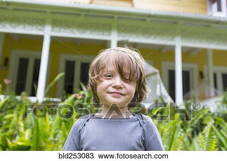 Smiling Caucasian boy in front of house View Large Photo Image Stock Image - Smiling Caucasian boy in front of house. Fotosearch