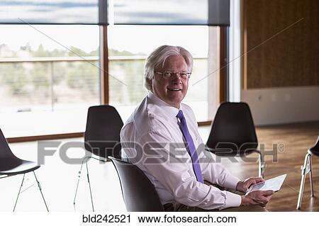 Smiling Caucasian businessman using digital tablet View Large Photo Image Stock Image - Smiling Caucasian businessman using digital tablet. Fotosearch