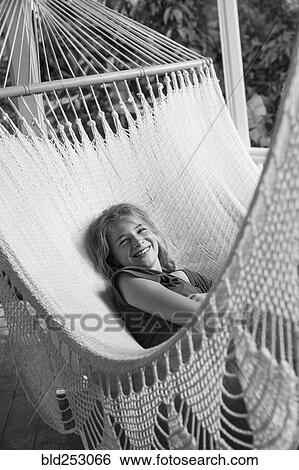 Smiling Caucasian girl laying in hammock View Large Photo Image Stock Photograph - Smiling Caucasian girl laying in hammock. Fotosearch