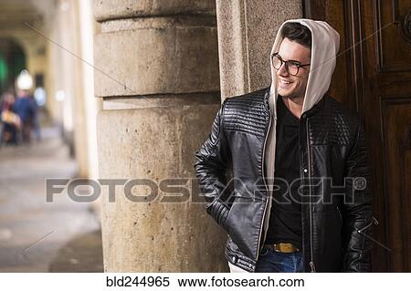 Smiling Caucasian man standing near door View Large Photo Image Stock Photography - Smiling Caucasian man standing near door. Fotosearch