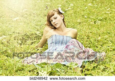 Smiling Caucasian teenage girl laying in grass View Large Photo Image Stock Image - Smiling Caucasian teenage girl laying in grass. Fotosearch
