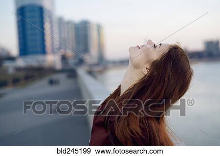 Smiling Caucasian woman at waterfront View Large Photo Image Stock Photo - Smiling Caucasian woman at waterfront. Fotosearch