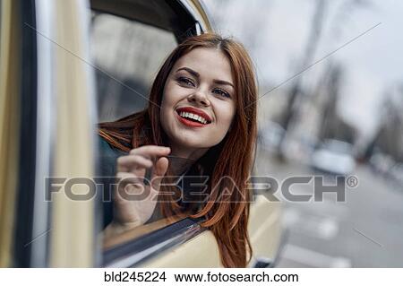 Smiling Caucasian woman in back seat of car View Large Photo Image Picture - Smiling Caucasian woman in back seat of car. Fotosearch
