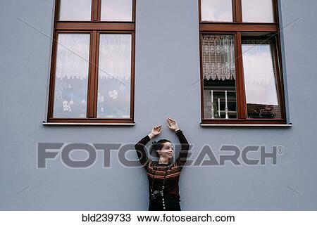 Smiling Caucasian woman leaning on wall View Large Photo Image Stock Image - Smiling Caucasian woman leaning on wall. Fotosearch