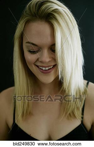 Smiling Caucasian woman looking down View Large Photo Image Stock Image - Smiling Caucasian woman looking down. Fotosearch
