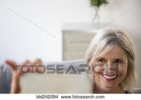 Smiling Caucasian woman posing for cell phone selfie View Large Photo Image Picture - Smiling Caucasian woman posing for cell phone selfie. Fotosearch