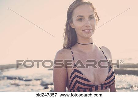 Smiling Caucasian woman wearing bikini on beach View Large Photo Image Stock Photo - Smiling Caucasian woman wearing bikini on beach. Fotosearch