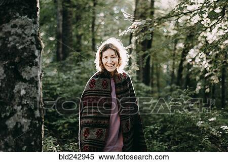 Smiling Caucasian woman wearing shawl in forest View Large Photo Image Stock Photography - Smiling Caucasian woman wearing shawl in forest. Fotosearch