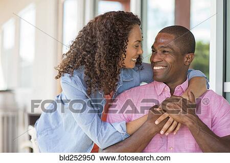 Stock Image - Smiling couple hugging. Fotosearch