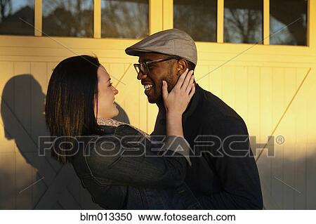 Smiling couple hugging View Large Photo Image Stock Image - Smiling couple hugging. Fotosearch
