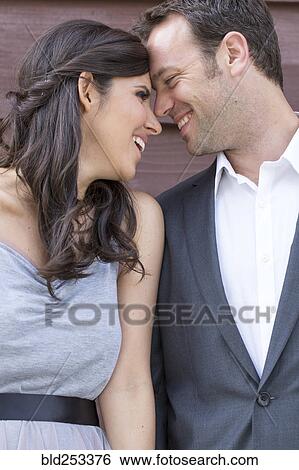 Stock Photograph - Smiling couple touching foreheads. Fotosearch