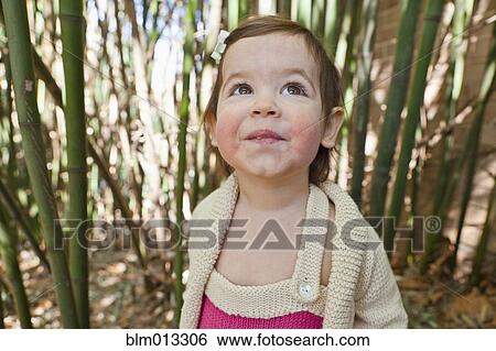 Stock Photograph - Smiling girl looking up. Fotosearch