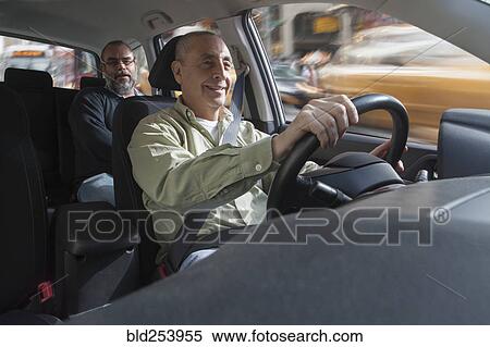 Smiling Hispanic man driving car with passenger View Large Photo Image Stock Photography - Smiling Hispanic man driving car with passenger. Fotosearch
