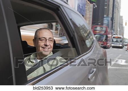 Smiling Hispanic man riding in car View Large Photo Image Stock Image - Smiling Hispanic man riding in car. Fotosearch