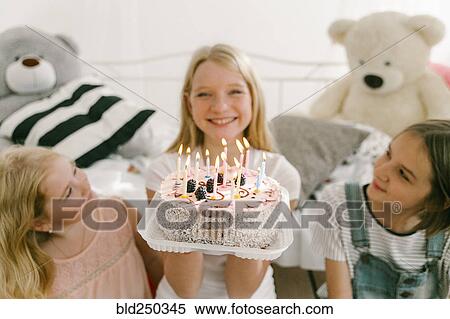 Smiling Middle Eastern sisters with birthday cake in bedroom View Large Photo Image Stock Photography - Smiling Middle Eastern sisters with birthday cake in bedroom. Fotosearch