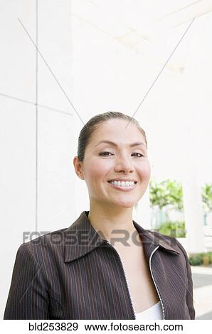 Smiling Mixed Race businesswoman outdoors View Large Photo Image Stock Photo - Smiling Mixed Race businesswoman outdoors. Fotosearch