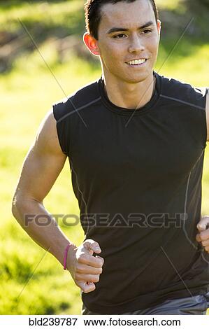 Stock Photo - Smiling Mixed Race man running. Fotosearch