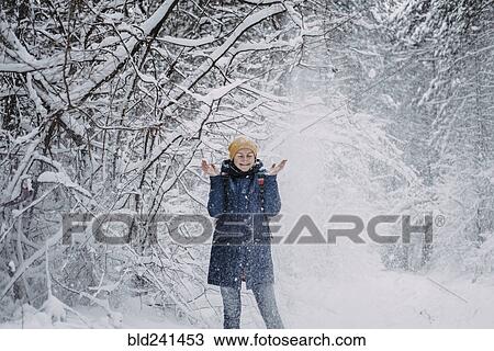 Snow falling on Caucasian woman in forest View Large Photo Image Stock Image - Snow falling on Caucasian woman in forest. Fotosearch