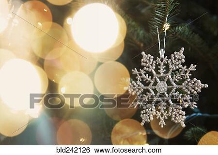 Snowflake ornament on Christmas tree View Large Photo Image Stock Photograph - Snowflake ornament on Christmas tree. Fotosearch