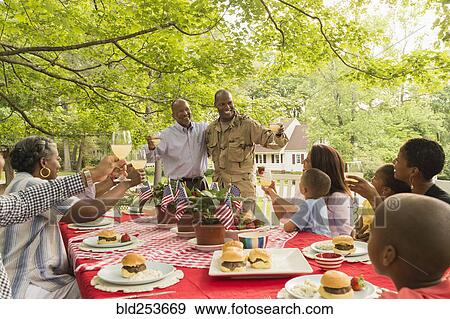 Soldier and multi-generation family toasting with lemonade at picnic View Large Photo Image Stock Photo - Soldier and multi-generation family toasting with lemonade at picnic. Fotosearch
