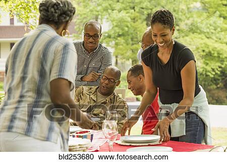 Stock Image - Soldier and relatives at picnic. Fotosearch