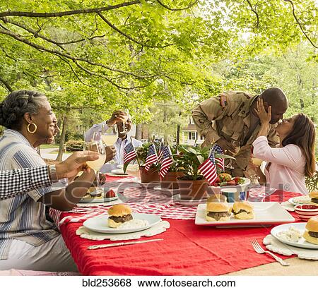Stock Photo - Soldier man kissing wife at picnic. Fotosearch