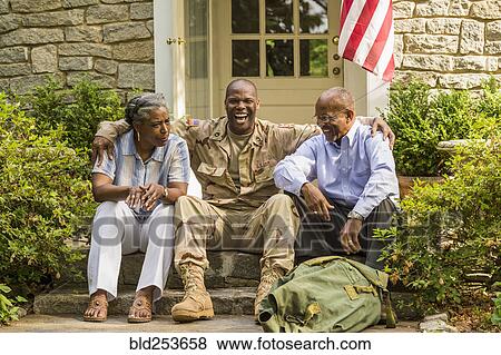 Soldier sitting on front stoop with parents View Large Photo Image Stock Photo - Soldier sitting on front stoop with parents. Fotosearch