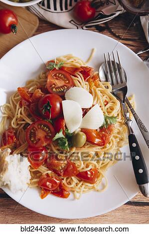 Spaghetti with bread and tomatoes View Large Photo Image Stock Image - Spaghetti with bread and tomatoes. Fotosearch