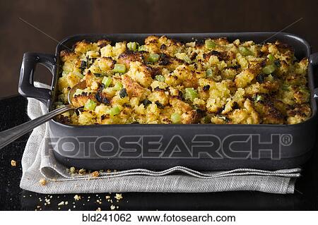 Stock Image - Spoon in tray of stuffing. Fotosearch