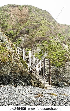 Stock Photography - Staircase to hill on rocky beach. Fotosearch