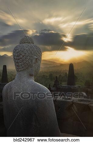 "Statue of Buddha at sunset, Borobudur, Java, Indonesia" View Large Photo Image Stock Photo - "Statue of Buddha at sunset, Borobudur, Java, Indonesia". Fotosearch