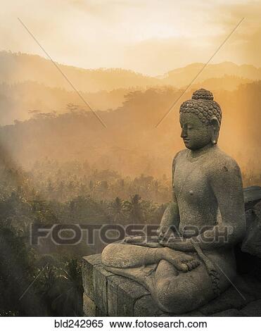 "Statue of Buddha at sunset, Borobudur, Java, Indonesia" View Large Photo Image Stock Photography - "Statue of Buddha at sunset, Borobudur, Java, Indonesia". Fotosearch